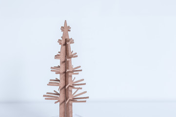 Christmas tree made of paper on white background. Abstract christmas card. Copy space for text.