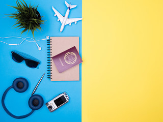 flat lay top view of traveler photographer accessories on yellow background. passport , camera , sunglasses , headphones