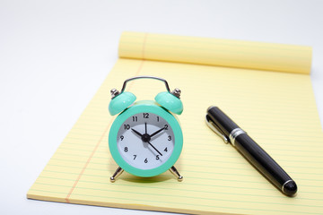 Alarm clock, notes and pen