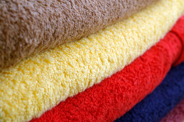 Texture of colored towels stacked in a pile