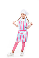 schoolchild in costume of chef holding braids and looking at camera isolated on white