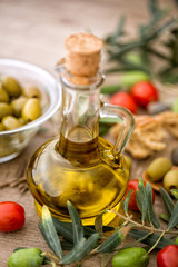Bottle of olive oil on the wooden table.
