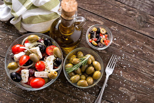 Mix of assorted whole Greek salad with olives top view .