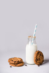 bottle of milk is decorated with cookies crumbs and chocolate chip cookies
