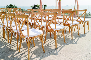Wooden folding lawn chairs with white fabric seat for destination wedding outdoors or modern wedding
