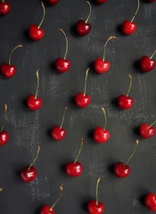 Fruit geometry from sweet cherry. Dark background. Top view