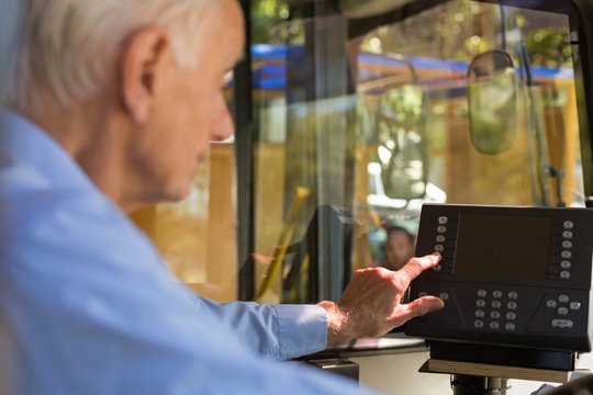 Driver operating machine in bus