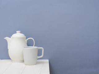 White Teapot and Cup on the Table in the kitchen.Indoor Interior. Scandinavian style. Live alone. 