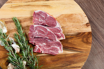 Raw lamb barbeque chops on chopping board