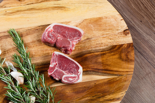 Raw Lamb Loin Slices On Chopping Board