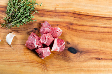 Raw diced beef on chopping board