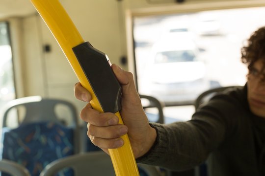 Man pressing button on pole