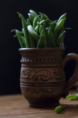 a lot of long green asparagus in a mug