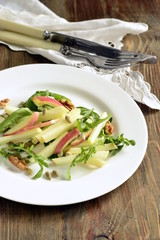 Apple salad with walnuts, pumpkin seeds and arugula