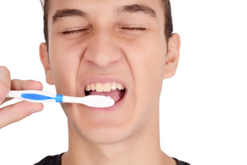 Close up of young man brushing his teeth