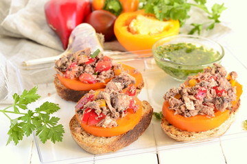 Bruschetta with tuna, tomatoes and sweet peppers with sauce
