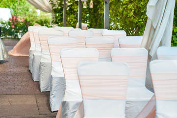 Wedding banquet tables preparing for a wedding outside on a summer day