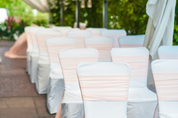 Wedding banquet tables preparing for a wedding outside on a summer day