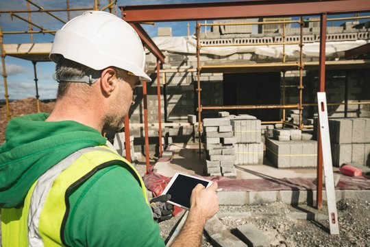 Engineer using digital tablet at the construction site