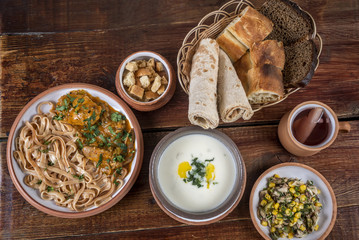 Soup with Greek yogurt, chicken, herbs and homemade noodles, salad with and chicken, rusks, basket...