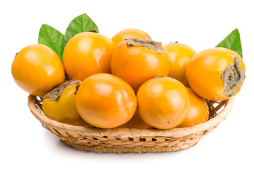 persimmons in basket on white background