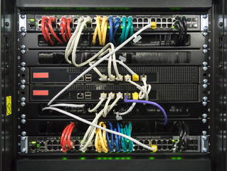 Detail of a communications rack, cables, switches and network