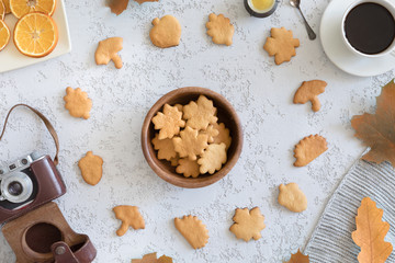 Top view of honey cookies in the shape of maple leaf on vintage autumn background, flat lay.