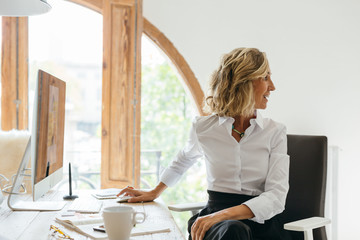 Mature businesswoman working at office.