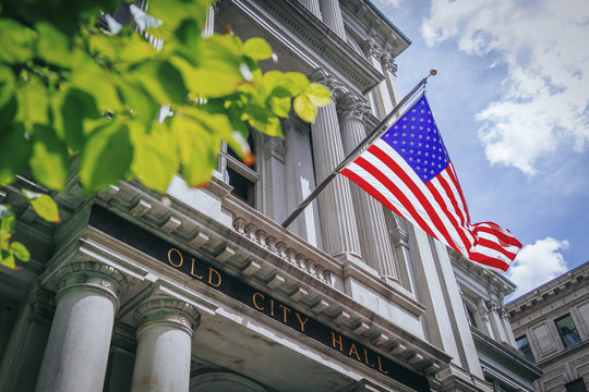 US Flag Flying Over Old City Hall In Boston, USA