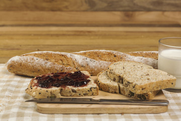 Morning easy breakfast, bread, jam , and cornflakes on wooden background