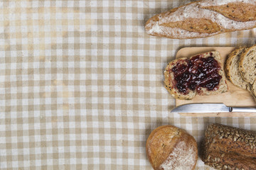 Morning easy breakfast, bread, jam , and cornflakes on wooden background