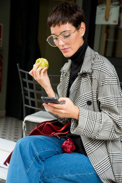 Stylish short haired business woman commuting between meetings on a busy city