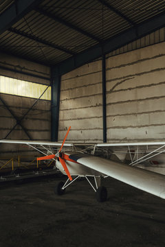Private small one engine plane in hangar.