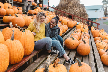Two best friends in their twenties at a pumpkin patch