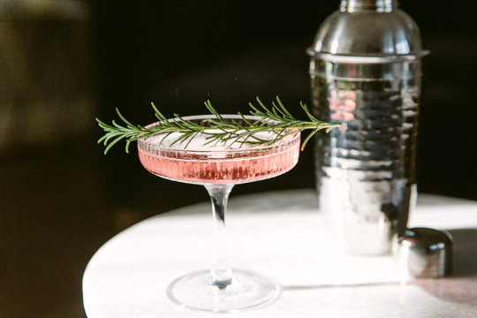 Pink coloured cocktail on a sunlit marble table