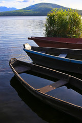 wooden boats on mountain lake