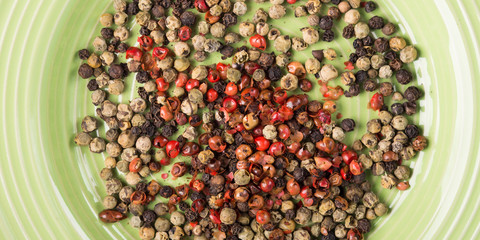 Mix of peppercorns - pink, black, green in a dish