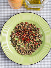 Mix of peppercorns - pink, black, green in a dish