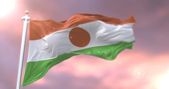 Flag of Niger waving at wind in slow at sunset, loop