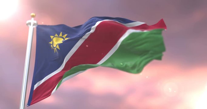 Flag of Namibia waving at wind in slow at sunset, loop