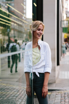 attractive young blonde woman smiling and playing with reflections