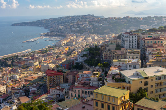 Naples hills on sunset with Mediterranean sea bay top view. Naples seashore. Travel concept. Aerial italian landscape. Neapol evening panorama. Vastness and vacation concept.