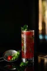 cocktail with whiskey, ice and orange peel on a dark background