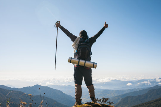 Mardi Himal Trek: Triumphant young man raising his hands on the himalayas.