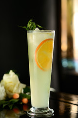 cocktail with orange and ice on a dark background