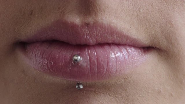 close up woman lips smiling happy wearing piercing makeup cosmetics feminine beauty