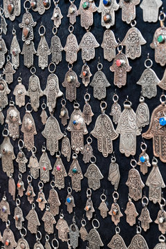 Fatima hands jewelry assortment in a souk market