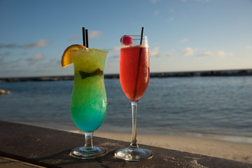Pair of Colorful cocktails on the beach .