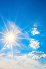 Naklejka na ściany i meble Hot summer or heat wave background, blue sky with glowing sun