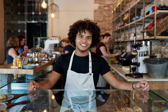 Cheerful male worker in cafeteria - Powered by Adobe